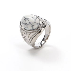 Macro shot of vintage silver ring featuring a white turquoise stone with grey veins