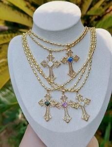 Baroque cross necklaces with colorful gemstones and pearls on white jewelry mannequins