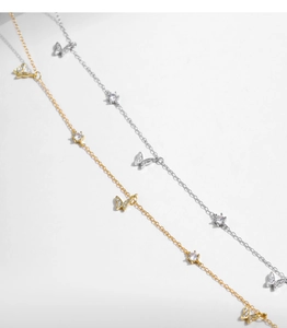 Detail of silver and gold butterfly necklaces with shimmering cubic zirconia accents