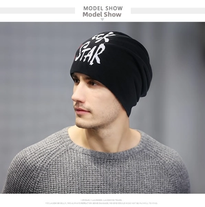 Detail of black knit beanie featuring a red and white STAR print on casual male model