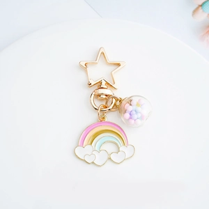 Rainbow balloon glass ball keychain with star clasp and colorful beads on white surface
