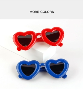Detail of trendy heart-shaped sunglasses in vibrant red and royal blue plastic frames
