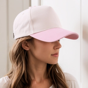 Two-tone cotton five-panel baseball cap in white and pink worn by a model in a studio
