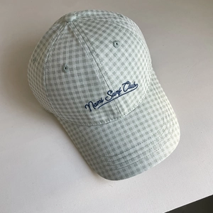 Detail of Gingham baseball cap with Nami Surf Club embroidery on a soft fabric