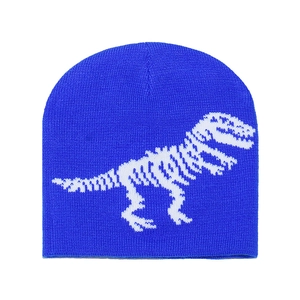Close-up of bright blue knit beanie featuring detailed white dinosaur skeleton pattern