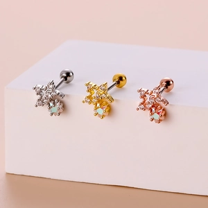 Detailed view of gold and silver zodiac stud earrings with sparkling crystal stones
