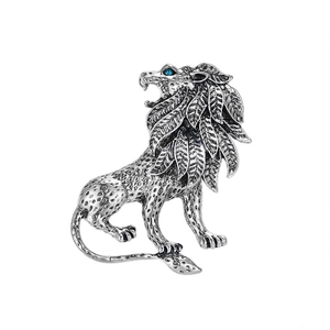 Detailed view of a silver lion brooch with blue gem eyes and leaf-shaped mane detail