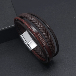 Detail of dark brown and red multi-layer braided leather bracelet with silver magnetic clasp