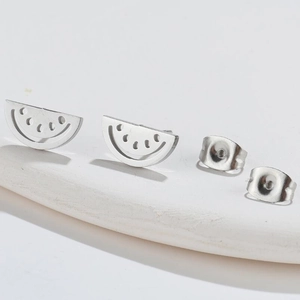 Minimalist silver watermelon slice stud earrings with hollow seed details and butterfly backings