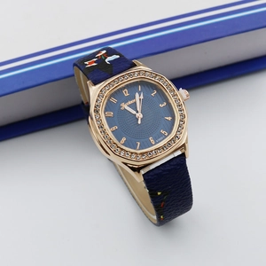 Detailed shot of a square rose gold watch with blue leather strap and crystal bezel
