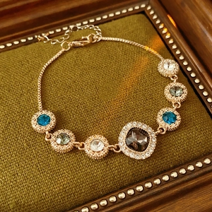 Detailed macro view of sparkling blue crystals and rose gold metal on a luxury bracelet