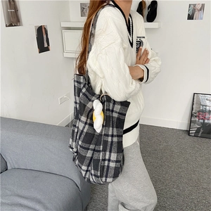 Detailed side view of large capacity plaid wool tote bag with soft cloud charm