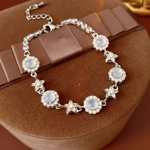 Detailed view of silver flower bracelet with blue chalcedony and cubic zirconia on gift box