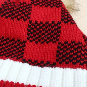 Winter knitted pom pom beanie with red and black buffalo plaid pattern and white ribbed cuff