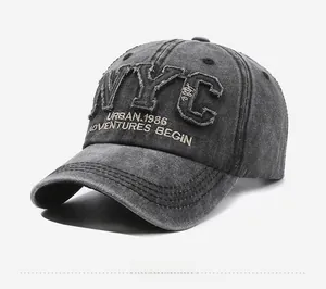 Close-up of NYC patchwork embroidery and vintage washed grey texture on baseball cap