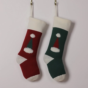Knitted Christmas stockings in red and green with festive 3D pom-pom hat patterns