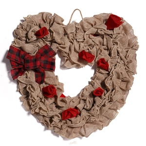 Handcrafted burlap heart wreath with red roses and plaid bow for festive door decoration