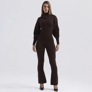 Detail of dark brown knit set featuring asymmetrical button neckline and flared trousers