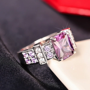 Macro detail of rectangle purple gemstone ring with micro-pave setting on silver band
