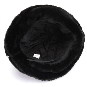 Detail of the black faux fur hat showing internal quilted lining and care label