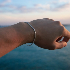 Minimalist silver stainless steel snake chain bracelet for men and women worn on wrist