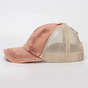 Side view of washed orange denim trucker hat with breathable beige mesh and stitch detail