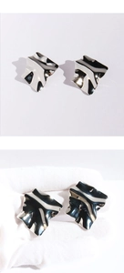 Detailed view of silver irregular wrinkled square earrings with metallic mirror finish