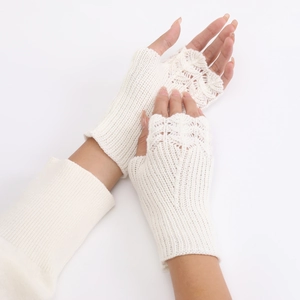 Close-up of white fingerless knit gloves with intricate fish scale crochet pattern