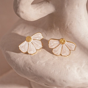 Elegant petal-shaped gold stud earrings with pearlescent white enamel on artistic stone