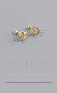 Detailed view of gold S925 silver heart earrings with zircon and screw back closure