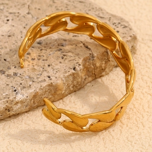 Detailed macro view of 18K gold plated stainless steel hollow leaf teardrop bangle