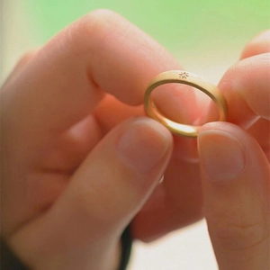 Detail of 18k gold plated matte ring featuring a star engraving and sparkling zircon