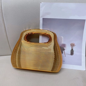 Golden acrylic box clutch with wavy texture and integrated handle for formal events