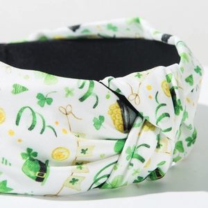 Close-up of knotted headband with Saint Patrick's Day shamrock and gold coin prints