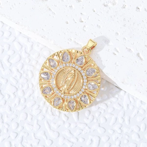 Golden Virgin Mary pendant with sparkling zircon halo on white textured background