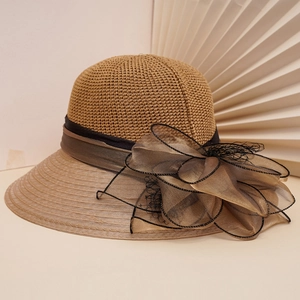 Elegant khaki straw sun hat with large chiffon bow and wide brim for summer beach style
