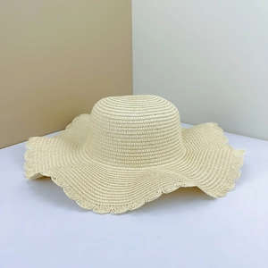 Minimalist cream straw sun hat with wavy wide brim for beach sun protection