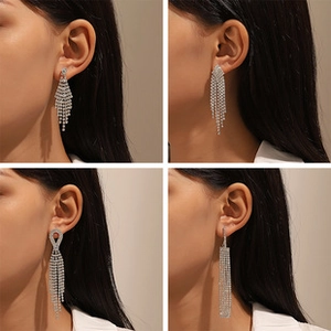 Detail view of four long silver tassel earrings with sparkling rhinestones in a grid layout