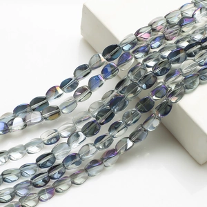 Macro shot of 10x12mm twisted oval crystal beads with iridescent blue finish for DIY crafts