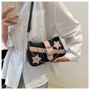 Detail of denim shoulder bag with pink star appliques and stylish silver chain strap