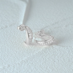 Detailed macro view of S925 sterling silver C-shaped star stud earrings with cubic zirconia