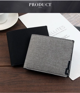 Detailed view of grey linen and black matte men's wallets with elegant metal edge trim