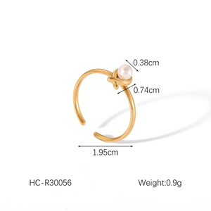 Detail view of 18K gold bow ring with pearl dimensions and adjustable opening size