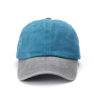 Close-up of a washed cotton baseball cap with blue crown and contrasting grey curved brim