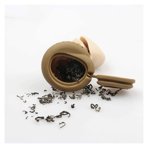 Funny silicone poop tea infuser in brown and beige colors with loose tea leaves