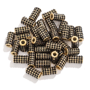 Macro view of gold metal beads with black rhinestones for DIY jewelry making