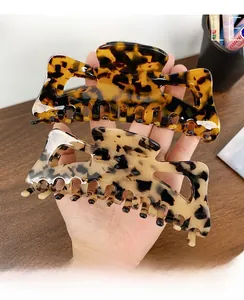 Close-up of oversized tortoise shell acetate hair claws showing smooth texture and grip