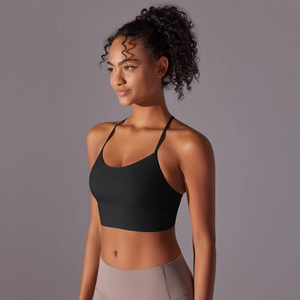 Detail of black sports bra with slim racerback straps and elastic seamless fabric