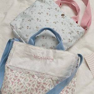 Close-up of floral canvas tote bag with lace flap and SoZakkaing embroidery detail