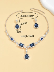 Detailed view of silver jewelry set with blue teardrop stones and product dimensions